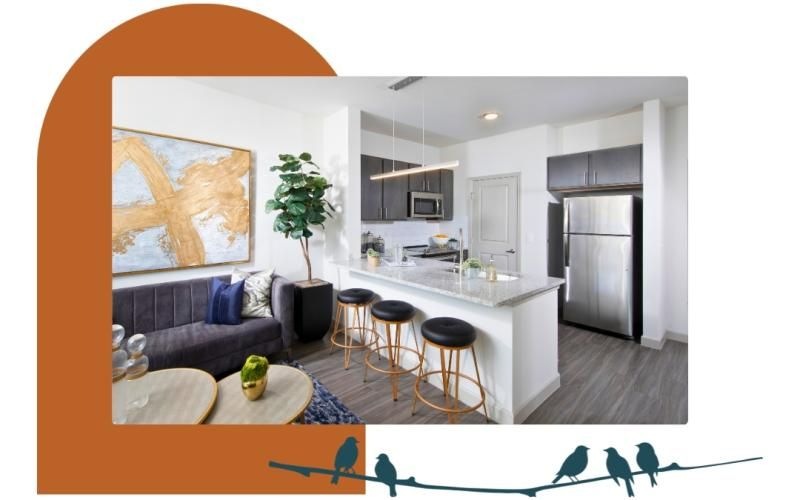 a kitchen with stools and a couch